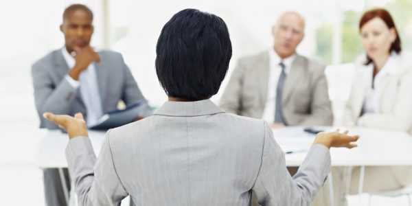 Woman being interviewed by a panel of interviewer